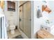 A bathroom with a toilet and glass shower door at 10910 Rushwood Way, Clermont, FL 34714