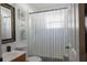 Bright bathroom featuring a classic vanity, toilet, and tub with shower and decorative accents at 10910 Rushwood Way, Clermont, FL 34714