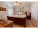 Spacious bedroom with a wooden bed frame and closet space at 10910 Rushwood Way, Clermont, FL 34714