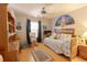 Light-filled bedroom featuring wood floors and a daybed under a ceiling fan at 10910 Rushwood Way, Clermont, FL 34714