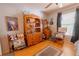 Charming bedroom features wood floors, a dresser, and a rocking chair by the window at 10910 Rushwood Way, Clermont, FL 34714
