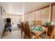 Inviting dining room with a wooden table set for a meal, surrounded by sunny window views at 10910 Rushwood Way, Clermont, FL 34714