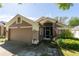 Charming single-story home featuring an attached garage and well-maintained landscaping with American Flag at 10910 Rushwood Way, Clermont, FL 34714