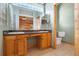 Well-lit bathroom with double sink vanity and separate toilet at 12047 Montevista Rd, Clermont, FL 34711