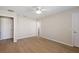 Spacious bedroom features a ceiling fan, wood-look floors, and neutral wall paint at 12050 Ne 51St Cir, Oxford, FL 34484