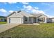 Inviting single-story home with neat landscaping and a two-car garage at 12050 Ne 51St Cir, Oxford, FL 34484