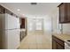 Bright kitchen with tiled floor featuring a breakfast nook and white appliances at 12050 Ne 51St Cir, Oxford, FL 34484