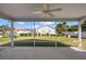 Screened lanai features a ceiling fan and overlooks the well-maintained backyard at 12050 Ne 51St Cir, Oxford, FL 34484