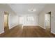 Inviting open-concept living room featuring wood floors, with a view to the kitchen and dining spaces at 12050 Ne 51St Cir, Oxford, FL 34484