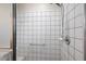 Shower with a chrome shower head, white tile surround, and a grab bar at 12050 Ne 51St Cir, Oxford, FL 34484