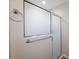 Shower with frosted glass door and chrome towel rack at 12050 Ne 51St Cir, Oxford, FL 34484