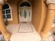 The front door is framed by two pillars and tile flooring with a welcome mat on the tile floor at 13742 Vista Del Lago Blvd, Clermont, FL 34711