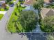 Overhead view of a well-maintained corner lot home with mature landscaping and a paver driveway at 1414 Georgetown Ave, The Villages, FL 32162