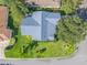 Overhead shot shows the home's roof, landscaping, and corner lot location within the neighborhood at 1414 Georgetown Ave, The Villages, FL 32162