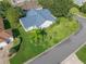 Beautiful aerial view of a landscaped home, located on a corner lot in a well-manicured community at 1414 Georgetown Ave, The Villages, FL 32162