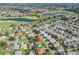 Aerial shot of a residential area features a golf course, lakes, and houses with well-maintained lawns at 1414 Georgetown Ave, The Villages, FL 32162