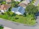 Overhead view of a meticulously landscaped home, situated on a corner lot with mature trees at 1414 Georgetown Ave, The Villages, FL 32162