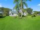 Spacious backyard showcases beautiful landscaping and a well-maintained lawn, enhancing curb appeal at 1414 Georgetown Ave, The Villages, FL 32162