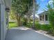 Serene backyard with lush landscaping including palm trees, creating a peaceful outdoor retreat at 1414 Georgetown Ave, The Villages, FL 32162