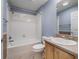 Bathroom featuring a tub-shower combo, neutral tile, and a wood vanity with a sink at 1414 Georgetown Ave, The Villages, FL 32162