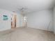 Bright and airy bedroom with ceiling fan, carpeted floors, and access to ensuite bathroom and closet at 1414 Georgetown Ave, The Villages, FL 32162