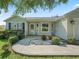 Close-up of the home's entrance showing a patterned brick walkway and quaint landscaping at 1414 Georgetown Ave, The Villages, FL 32162