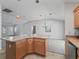 Open kitchen concept with an island overlooking the living space, featuring modern appliances and ample counter space at 1414 Georgetown Ave, The Villages, FL 32162