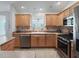 Functional kitchen with stainless steel appliances, light wood cabinetry, and neutral countertops at 1414 Georgetown Ave, The Villages, FL 32162