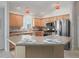Well-appointed kitchen featuring stainless steel appliances, warm wood cabinets, and a functional island at 1414 Georgetown Ave, The Villages, FL 32162