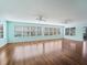 Spacious living room with hardwood floors, two ceiling fans, and many large windows at 1414 Georgetown Ave, The Villages, FL 32162