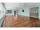 Open-concept living room featuring hardwood floors, large windows, and easy access to other rooms at 1414 Georgetown Ave, The Villages, FL 32162