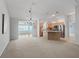 Open-concept living space featuring a view to kitchen, neutral carpet and colors providing a seamless flow at 1414 Georgetown Ave, The Villages, FL 32162