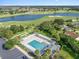 Stunning aerial view of the community pool, cabana, lawn bowling and golf course at 1414 Georgetown Ave, The Villages, FL 32162
