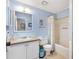 Bright bathroom featuring a shower-tub combo, and a single sink vanity with an inset sink and white cabinets at 1523 W Schwartz Blvd, The Villages, FL 32159