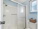 Clean bathroom with a glass-enclosed shower and ample storage space at 1523 W Schwartz Blvd, The Villages, FL 32159