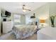 Comfortable bedroom featuring a ceiling fan, a bed, and light-filled space at 1523 W Schwartz Blvd, The Villages, FL 32159