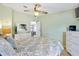 Comfortable bedroom featuring a ceiling fan, a bed, and light-filled space at 1523 W Schwartz Blvd, The Villages, FL 32159