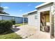 Backyard patio offers extra storage space with an outdoor storage closet and lawn views at 1523 W Schwartz Blvd, The Villages, FL 32159