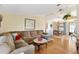 Cozy living room with a large sectional couch and hardwood floors provides an inviting space at 1523 W Schwartz Blvd, The Villages, FL 32159