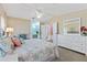 Bright main bedroom with large dresser, ceiling fan and ensuite bathroom at 1523 W Schwartz Blvd, The Villages, FL 32159