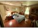 A well-lit bedroom, complete with wood-look floors, neutral walls, and ample closet space at 1532 W Schwartz Blvd, Lady Lake, FL 32159