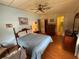 Comfortable bedroom featuring a bed, wood-look floors, closet, and access to the bathroom at 1532 W Schwartz Blvd, Lady Lake, FL 32159