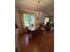 Charming dining area with a chandelier, laminate flooring, and natural light at 1532 W Schwartz Blvd, Lady Lake, FL 32159