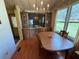 Open dining area featuring a chandelier, laminate flooring, and natural light at 1532 W Schwartz Blvd, Lady Lake, FL 32159