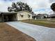 Charming single-story home with manicured lawn, covered parking, and paved driveway at 1532 W Schwartz Blvd, Lady Lake, FL 32159