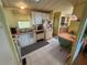 Functional kitchen with white cabinetry, appliances, and a cozy dining area at 1532 W Schwartz Blvd, Lady Lake, FL 32159