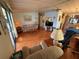 Cozy living room with laminate floors, ceiling fan, and view to the kitchen at 1532 W Schwartz Blvd, Lady Lake, FL 32159