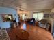 Spacious living room featuring bright windows, ceiling fan, and access to dining area at 1532 W Schwartz Blvd, Lady Lake, FL 32159