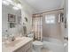 Bathroom featuring a neutral-toned shower, tub, and vanity with decorative palm tree accents at 17504 Se 119Th Cir, Summerfield, FL 34491