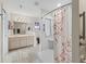 Bathroom featuring a large vanity with double sinks and walk in shower with grab bars at 17504 Se 119Th Cir, Summerfield, FL 34491